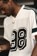 Adidas Tyshawn Jersey - white/ice gold metallic/collegiate green - lifestyle 1
